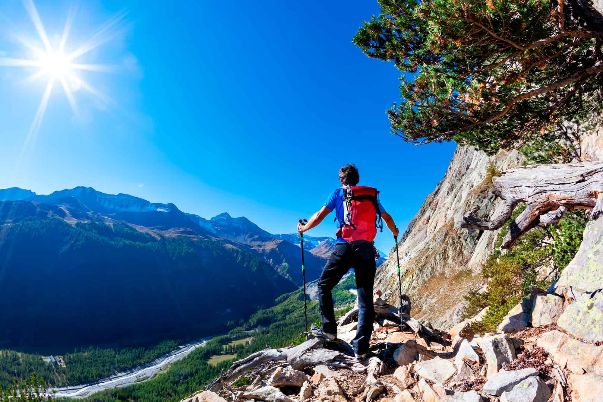 Hiker takes a rest observing a mountain panorama. Mont Blanc Massif, Italian Alps,